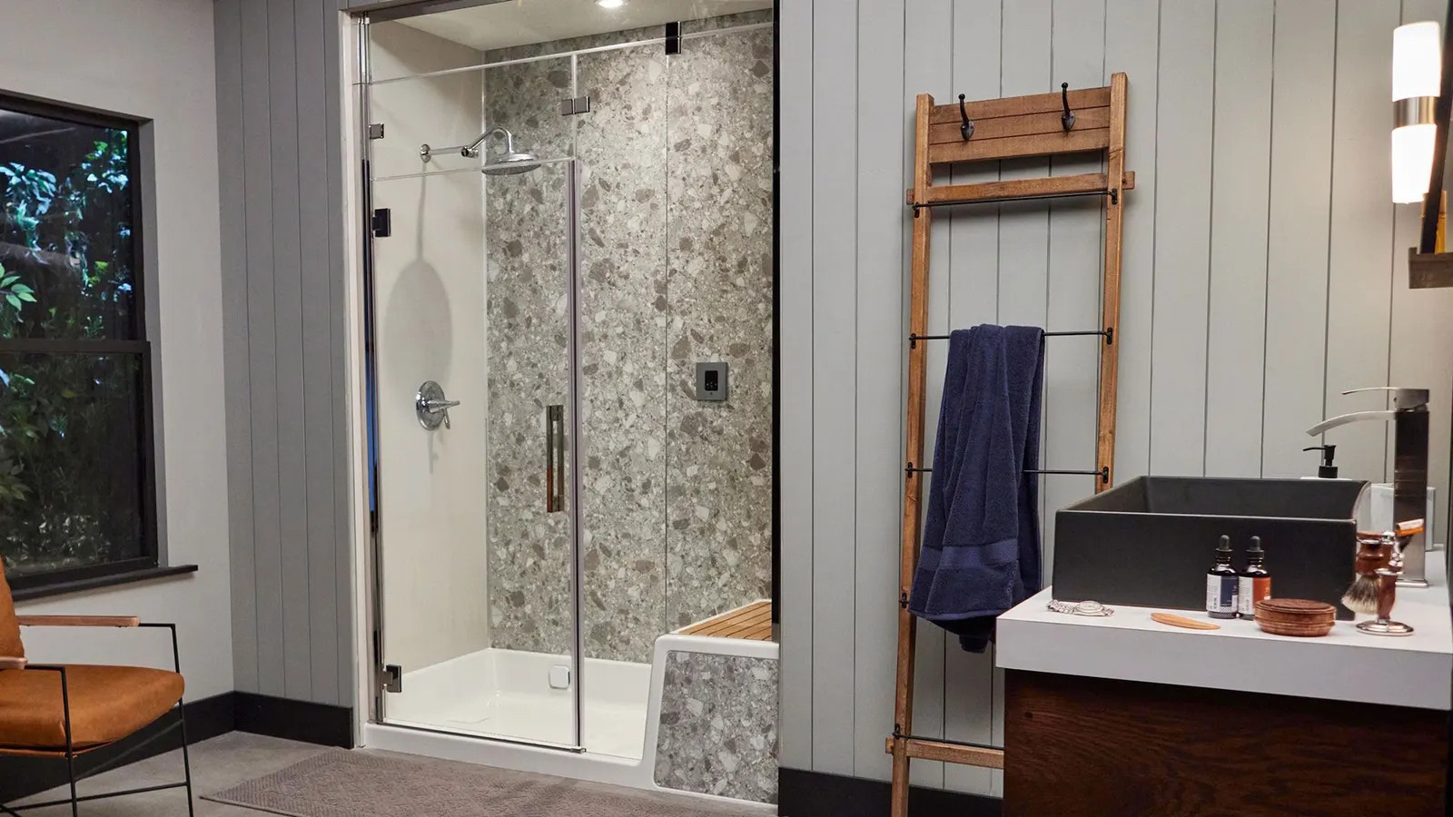 Jacuzzi® shower with pebble-look walls and a glass door