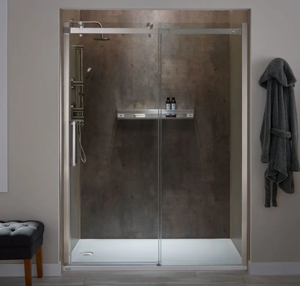 Jacuzzi® shower with dark walls and a roller glass door
